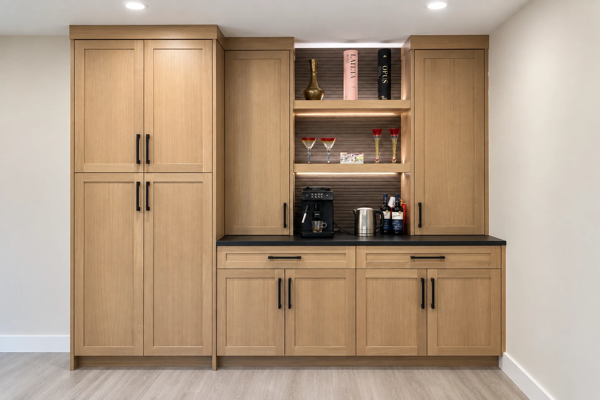 Custom millwork and built-in cabinetry by UpRight Reno in Calgary, featuring light wood cabinets, open shelving and a custom coffee bar.